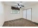 Bedroom features neutral carpet, a ceiling fan, and natural light from large windows at 3557 Wayne Cir, Las Vegas, NV 89121