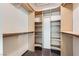 Walk-in closet with custom built-in shelving, clothing rods and carpet floors at 3557 Wayne Cir, Las Vegas, NV 89121