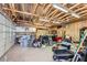 Large garage with exposed rafters and fluorescent lighting provides ample space for projects and storage at 3557 Wayne Cir, Las Vegas, NV 89121