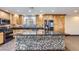 Spacious kitchen featuring custom wood cabinetry, stainless steel appliances, and a large mosaic-tiled island at 3557 Wayne Cir, Las Vegas, NV 89121