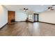An expansive living room featuring wood tile floors, a brick fireplace, and dark wood-trimmed windows at 3557 Wayne Cir, Las Vegas, NV 89121