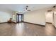 An expansive living room featuring wood tile floors, dark wood-trimmed windows, and recessed lighting at 3557 Wayne Cir, Las Vegas, NV 89121