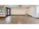 A bright living room with wood tile floors, dark wood-trimmed windows, and recessed lighting at 3557 Wayne Cir, Las Vegas, NV 89121
