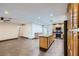 Open-concept living area with tile flooring, ceiling fans, adjacent to the kitchen, and access to the backyard at 3557 Wayne Cir, Las Vegas, NV 89121