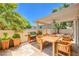 Outdoor patio with dining table, barbecue grill, and landscaped surroundings perfect for outdoor entertainment at 3640 Shanagolden St, Las Vegas, NV 89129