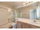 Bright bathroom with a shower and tub combination and a large mirror above the vanity at 3640 Shanagolden St, Las Vegas, NV 89129