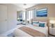 Well-lit bedroom with mirrored closet doors, stylish bedside tables, and neutral decor at 3640 Shanagolden St, Las Vegas, NV 89129
