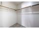 A walk-in closet featuring a wood bar for hanging clothes and carpeted flooring at 3640 Shanagolden St, Las Vegas, NV 89129