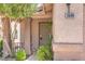 Inviting front porch with decorative pillars, security door, and a well-manicured garden at 3640 Shanagolden St, Las Vegas, NV 89129