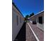 View of the side yard area with gravel and access between two buildings at 4420 Loma Ct, Las Vegas, NV 89130