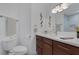 Modern bathroom featuring a vanity with a sink, a toilet, and a tiled shower for comfort at 4420 Loma Ct, Las Vegas, NV 89130