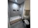 Updated bathroom featuring tile surround, inset shelves and updated fixtures at 4420 Loma Ct, Las Vegas, NV 89130