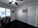 A bedroom with black floors, a large window, closet and ceiling fan with lights at 4420 Loma Ct, Las Vegas, NV 89130