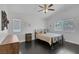 Large bedroom with hardwood floors, ceiling fan, a queen bed and two windows at 4420 Loma Ct, Las Vegas, NV 89130