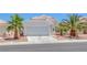 Charming single-story home with a two-car garage, well-manicured landscaping and palm trees at 4420 Loma Ct, Las Vegas, NV 89130