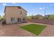 Spacious backyard with a small turf area and rock at 4498 Lantern Point Ave, North Las Vegas, NV 89084
