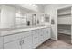 This bathroom has granite countertops, white cabinets, and double sinks at 4498 Lantern Point Ave, North Las Vegas, NV 89084