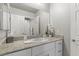 This bathroom has granite countertops, white cabinets, and a large mirror at 4498 Lantern Point Ave, North Las Vegas, NV 89084