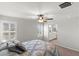 This bedroom has a window with shutter blinds and a ceiling fan at 4498 Lantern Point Ave, North Las Vegas, NV 89084