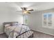 Comfortable bedroom with a ceiling fan, window shutters, and a well-appointed bed at 4498 Lantern Point Ave, North Las Vegas, NV 89084