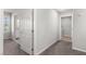 This hallway leads to the bathroom and has gray carpet at 4498 Lantern Point Ave, North Las Vegas, NV 89084