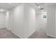 Upstairs hallway with gray carpet, leading to multiple rooms at 4498 Lantern Point Ave, North Las Vegas, NV 89084