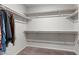 This is a walk-in closet with wood shelving and gray carpet at 4498 Lantern Point Ave, North Las Vegas, NV 89084
