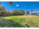 Expansive backyard with a lush green lawn and mature trees at 4683 Monterey Cir # 4, Las Vegas, NV 89169