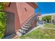 Exterior staircase leading to upper-level apartment, with secure access and landscaping at 4683 Monterey Cir # 4, Las Vegas, NV 89169