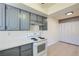 Cozy kitchen with gray cabinets, white countertops, and modern lighting at 4683 Monterey Cir # 4, Las Vegas, NV 89169