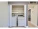 Washer and Dryer located in the laundry closet with extra shelving at 4683 Monterey Cir # 4, Las Vegas, NV 89169