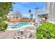 Landscaped backyard with pool, rock features, outdoor kitchen, and patio area at 511 Beaconwood St, Henderson, NV 89052
