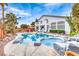 Inviting backyard pool and spa with rock features and desert landscaping create a relaxing outdoor living space at 511 Beaconwood St, Henderson, NV 89052