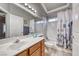 Bathroom featuring single vanity and shower-tub combo with floral curtain at 511 Beaconwood St, Henderson, NV 89052
