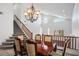 Dining room with chandelier lighting, and stairs leading to the second floor at 511 Beaconwood St, Henderson, NV 89052
