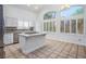 Open-concept kitchen featuring stainless steel appliances, an island cooktop, and light-filled windows at 511 Beaconwood St, Henderson, NV 89052