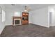 Living room with wood floors, fireplace, and built-in wooden shelving unit and backyard views at 511 Beaconwood St, Henderson, NV 89052