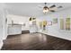 Spacious living room with wood floors, ceiling fan, and view of the kitchen at 511 Beaconwood St, Henderson, NV 89052