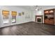 Living room with French doors to backyard, fireplace, and built-in wooden shelving unit at 511 Beaconwood St, Henderson, NV 89052