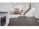 Open floor plan with living room, fireplace, dining area, and hardwood floors at 511 Beaconwood St, Henderson, NV 89052