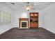 Living room with dark wood floors, fireplace, and built-in wooden shelving unit at 511 Beaconwood St, Henderson, NV 89052