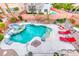 Aerial view of pool with waterfall, rock features, lounge chairs and landscaped backyard at 511 Beaconwood St, Henderson, NV 89052