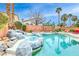 Inviting pool and spa with rock features and tropical landscaping at 511 Beaconwood St, Henderson, NV 89052