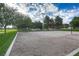 A sand volleyball court, surrounded by green grass and trees with a net at 511 Beaconwood St, Henderson, NV 89052