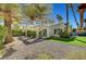 Spacious backyard with patio, artificial turf, and desert landscaping at 5224 Painted Lakes Way, Las Vegas, NV 89149
