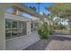 Open back patio with landscaping and large sliding doors at 5224 Painted Lakes Way, Las Vegas, NV 89149