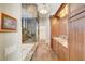 Modern bathroom with tiled floors, dual vanities, soaking tub, and glass enclosed shower at 5224 Painted Lakes Way, Las Vegas, NV 89149