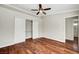 Bright bedroom featuring a ceiling fan, hardwood floors, and a closet at 5224 Painted Lakes Way, Las Vegas, NV 89149