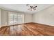 Empty bedroom with wood floors, a ceiling fan, and a window at 5224 Painted Lakes Way, Las Vegas, NV 89149