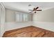 Bedroom features shuttered windows, a ceiling fan, and hardwood floors at 5224 Painted Lakes Way, Las Vegas, NV 89149